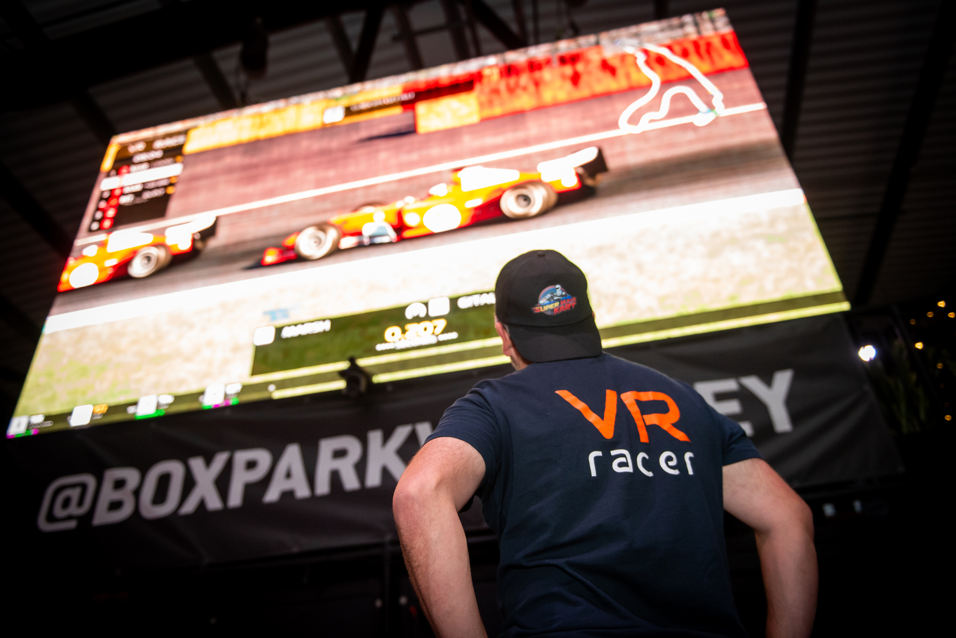 Driver watching live race broadcast at Boxpark Wembley